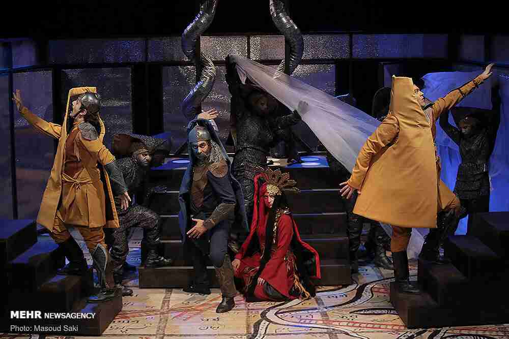 Image shows actors from the play "Sugjameh" acting out a scene. 